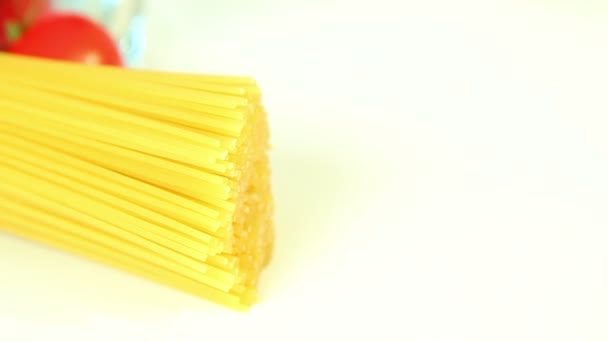 Italian food ingredients on white background, tomato with pasta spaghetti — Stock Video
