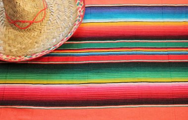 Fiesta mexican poncho rug in bright colors with sombrero background with copy space stock, photo, photograph, image, picture, clipart