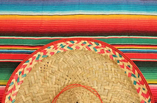 Cinco de mayo Mexican Fiesta poncho rug in bright colours with sombrero background with copy space stock, photo, photograph, image, picture, — Stock Photo, Image