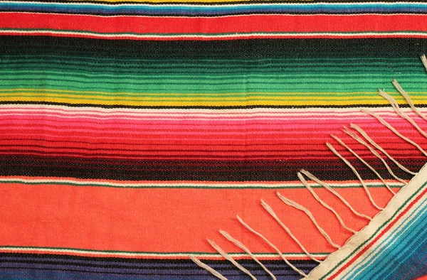 Cinco de mayo Mexican background  poncho serape blanket fiesta traditional Hispanic culture craft fabric handwoven rug with stripes and bright colours copy space stock, photo, photograph, image, picture, — Stock Photo, Image