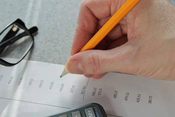 Accounting Bank statement with hand pencil and calculator — Stock Photo, Image