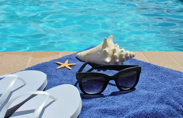 Vacaciones junto a la piscina pintoresca piscina gafas de sol de verano toalla de concha — Foto de Stock