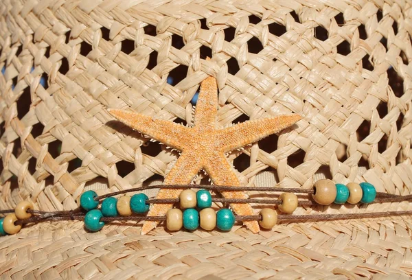Straw beach cowboy hat beads and starfish — Stock Photo, Image