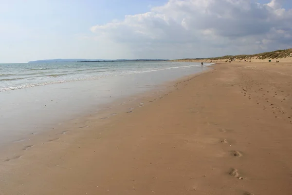 Camber sands East Sussex UK - view of Camber Sand dunes with sky and sea dunes held together with grasses stopping sand blowing away