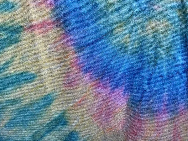 tie dye vivid colourful rainbow background swirl with copy space, tie dye popular with hippy in 70s yellow green blue red pink