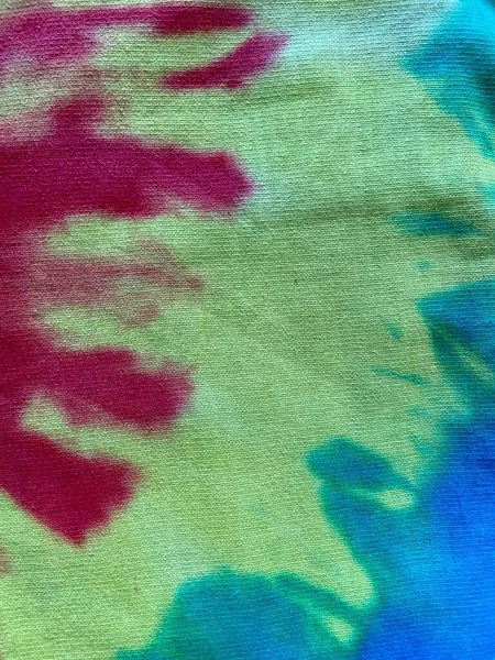 tie dye vivid colourful rainbow background swirl with copy space, tie dye popular with hippy in 70s yellow green blue red pink