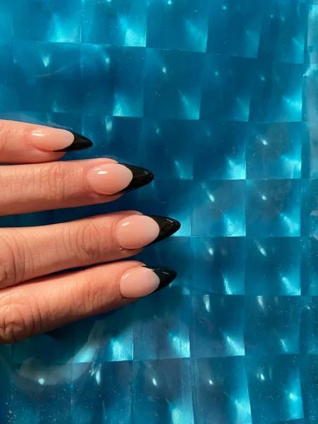 Black tip  flesh nude French manicure with claw points trendy nail design in acrylic applied nail art