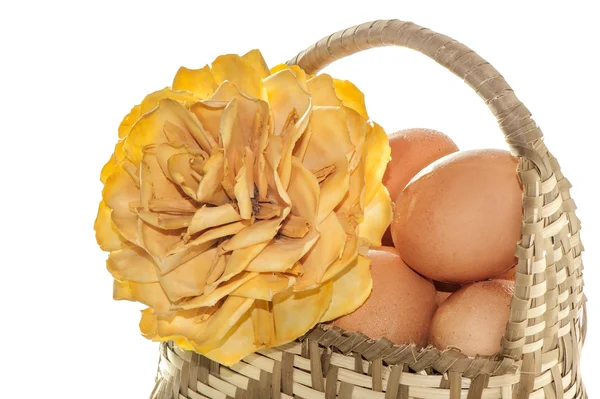 Natural basket with eggs and flowers — Stock Photo, Image