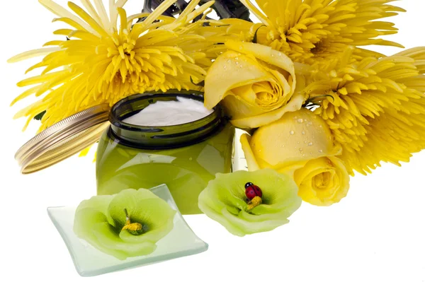 Yellow flowers ,candle and body lotion — Stock Photo, Image