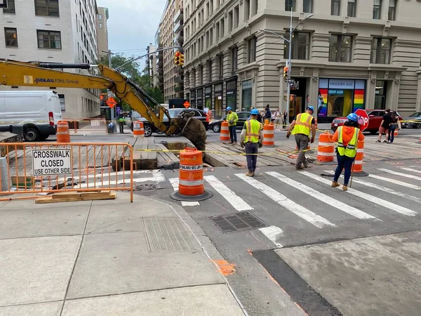 New York, NY, USA - July 9, 2022: Wooden planks are being moved to enable workers to install new as lines