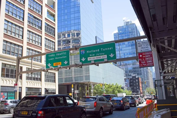 New York, NY, USA - July 16, 2022: Overhead signs direct drivers to correct lane to enter Holland Tunnel with warnings
