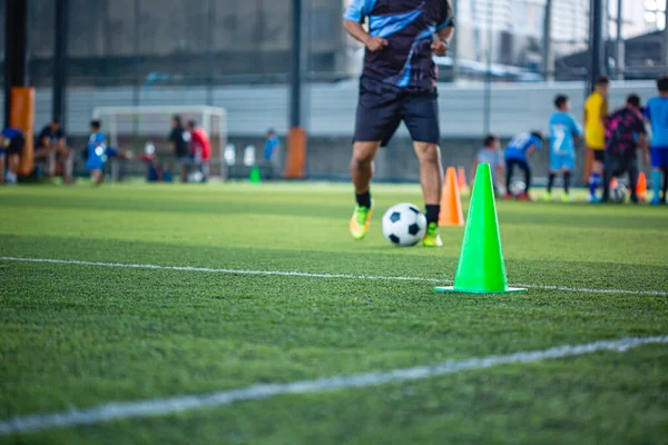 Soccer ball tactics cone on grass field with for training background