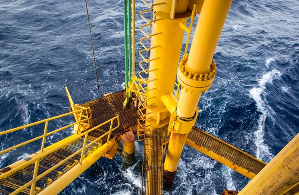 Offshore drill yellow and gas production petroleum pipeline waves sea.