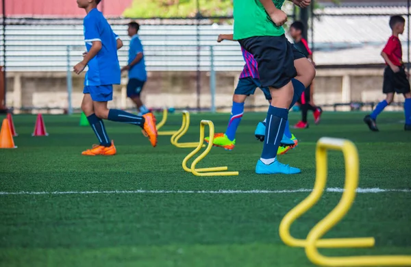 Soccer ball tactics on grass field with barrier cone  for training children jump skill in Soccer academy