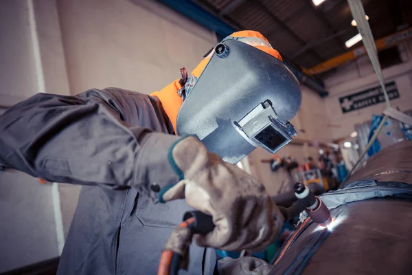 Male  worker wearing protective clothing of repair pipe stainless argon welding industrial construction