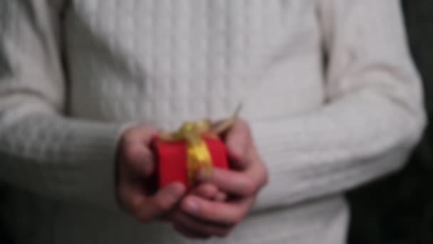 Close Hands Man White Sweater Holding Out Red Gift Box — Stock Video
