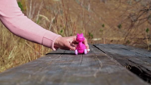 Hand Van Vrouw Geeft Kleine Speelgoed Uurwerk Dinosaurus Wielen Die — Stockvideo