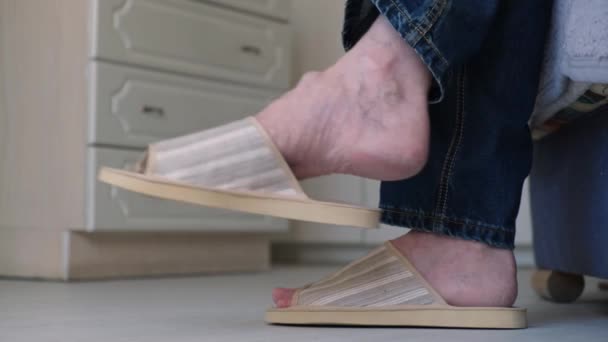Крупним Планом Чоловічі Ноги Джинсах Домашньому Взутті Чоловік Сидить Дивані — стокове відео