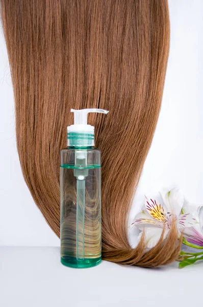 Cosmetic hair oil on a white background. Hair care. Healthy and beautiful hair. Copy space for text