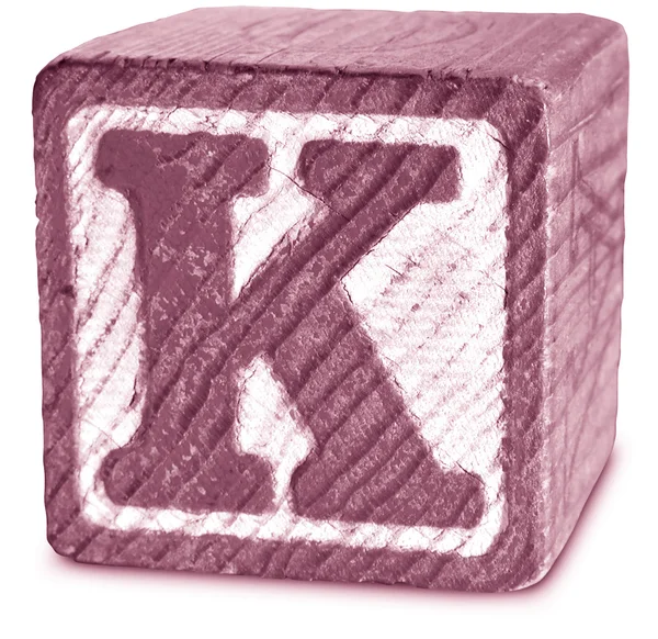 Фото Magenta Wooden Block Letter K — стоковое фото