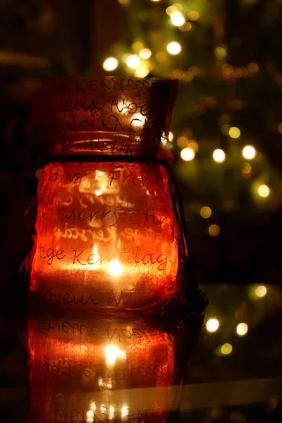 Candle inside the bottle with Christmas decoration — Stock Photo, Image