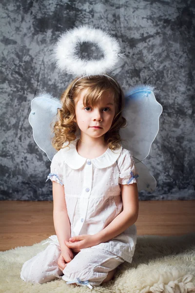 Portrait of curly girl with angel wings — Stock Photo, Image