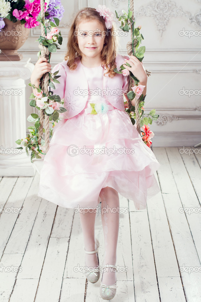 Portrait of a girl sitting on a swing