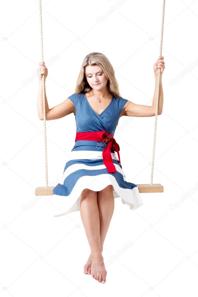 Beautiful blond woman on a swing