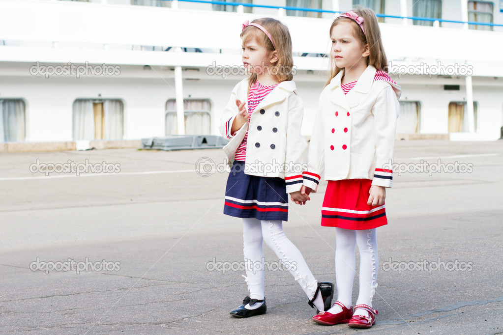 Two little happy girls in port