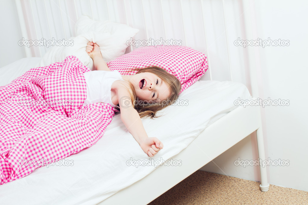 Young girl wakes up in the morning
