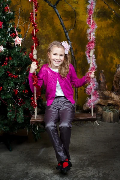 Little girl sitting on the swing — Stock Photo, Image