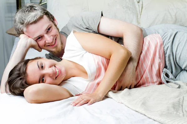 Älskande par avkopplande på sängen — Stockfoto