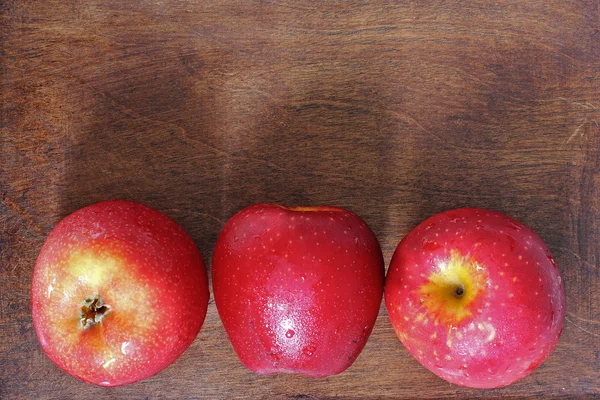 Three apples on wood — Stock Photo, Image