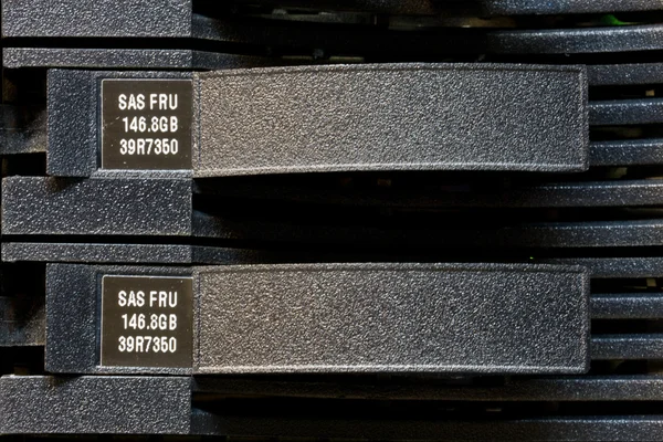 Row of hard drives mounted in a rack in a data center — Stock Photo, Image