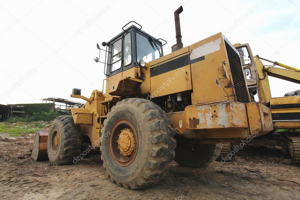 loader Excavator with backhoe unloading sand at eathmoving works