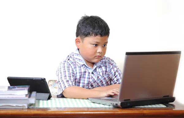 Asian boy was playing with my notebook. — Stock Photo, Image