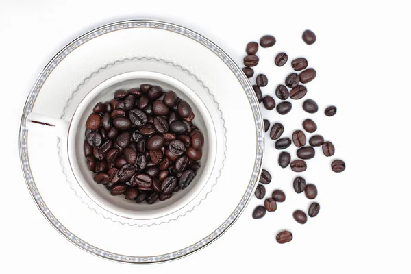 Coffee beans in a glass on a white background. — Stock Photo, Image