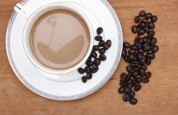 Coffee beans with coffee. wood background — Stock Photo, Image