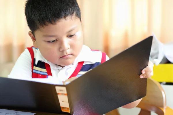 Checking documents The boy intently. — Stock Photo, Image