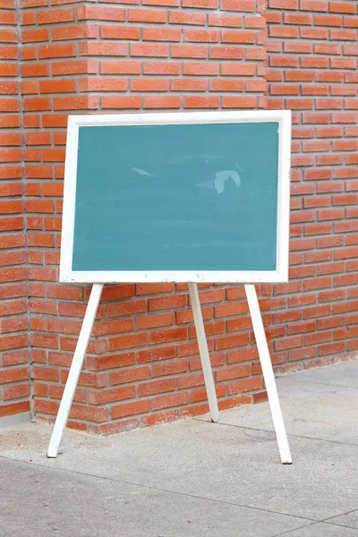 Chalk board front red brick wall — Stock Photo, Image