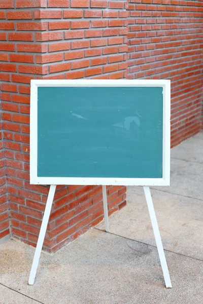 Chalk board front red brick wall — Stock Photo, Image