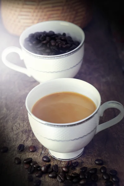 杯咖啡和咖啡豆的木桌上 — 图库照片