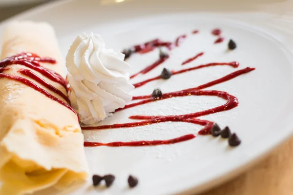 Crepe and ice cream topped with strawberry sauce flavored berrie — Stock Photo, Image