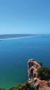 Shoreline of the Nazare beach in Portugal short vertical video from above. 