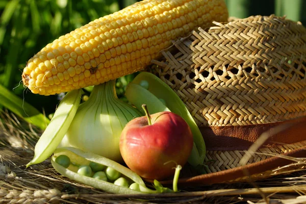 Peas, corn, apple and ears of wheat — Stock Photo, Image