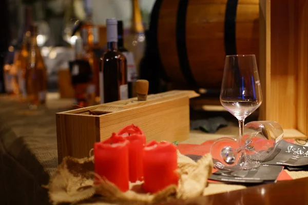 Still life with wine bottle, glass, cork and candles — Stock Photo, Image