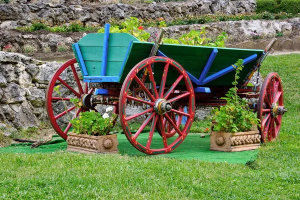 Garden decoration. Cart with flowers. Royalty Free Stock Images