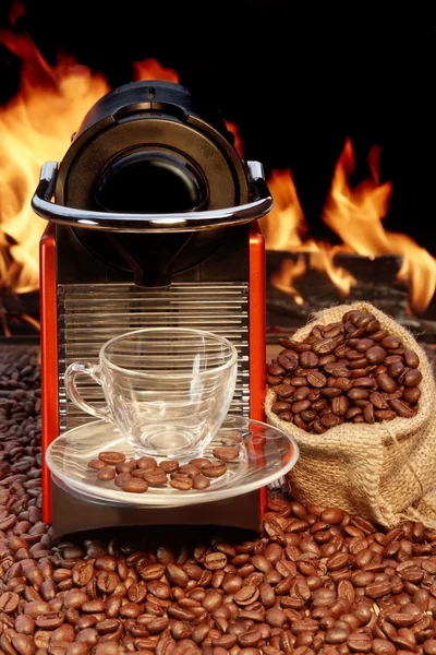 Coffee machine with cup of espresso near fireplace — Stock Photo, Image