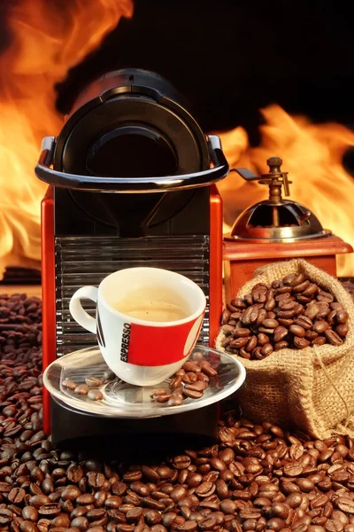Capsule Coffee machine with espresso cup near fireplace — Stock Photo, Image