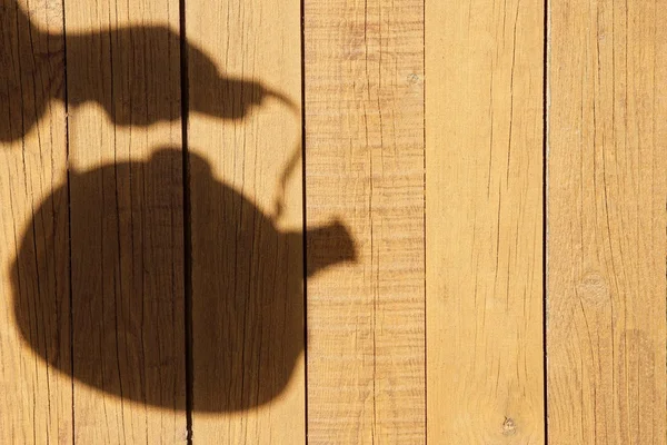 Silhouette with Kettle on the Natural Wooden Panel — Stock Photo, Image